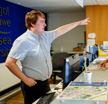 A member of reception staff directing someone