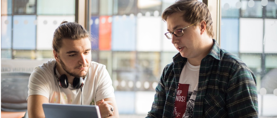 two students using laptop