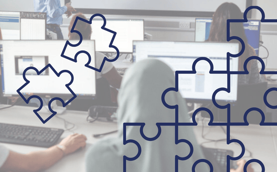 A student using a PC surrounded by puzzle pieces 