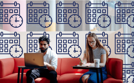 Navy calendars and clocks behind two students using laptops.