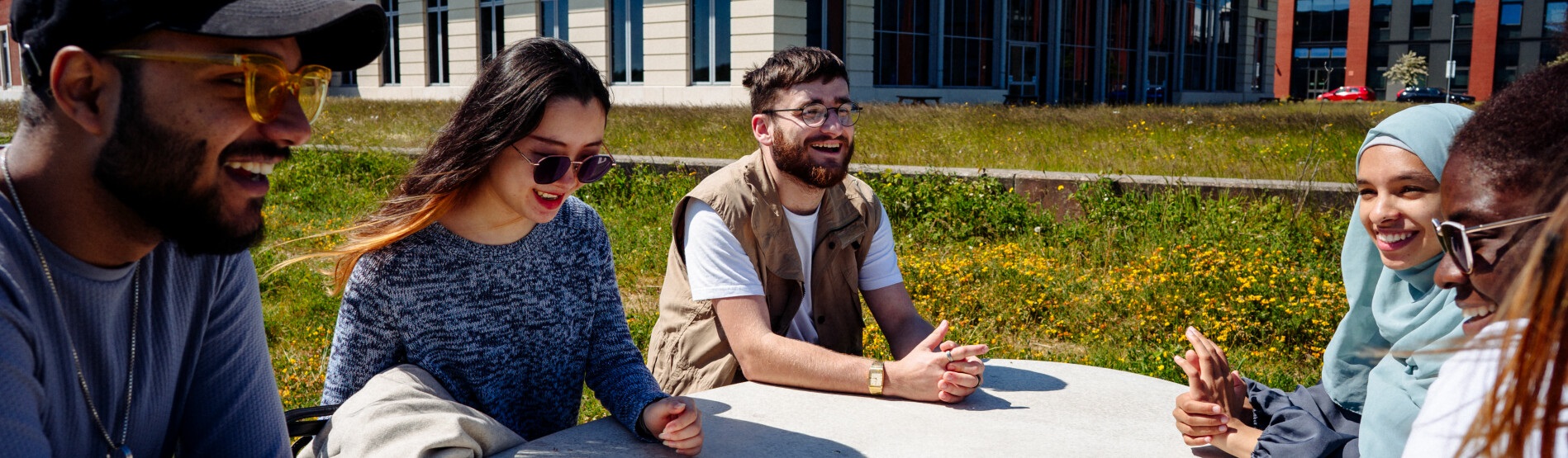 Students sitting outside on Bay Campus 