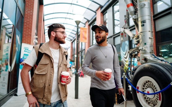 two students chatting while walking on Bay Campus