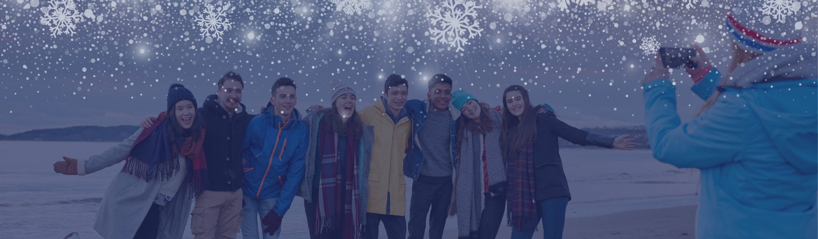 Students taking photos on the beach