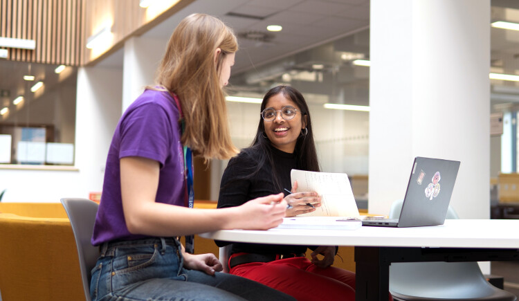 Students sitting and chatting in Library