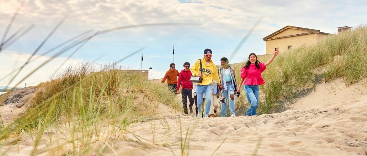 Students walking near sand