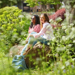 Two students having a conversation in gardens