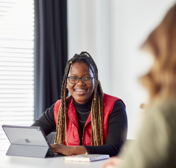 Student smiling by laptop