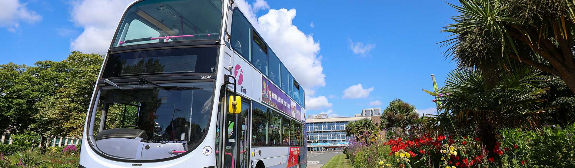 A First Bus driving down the main driveway of singleton campus