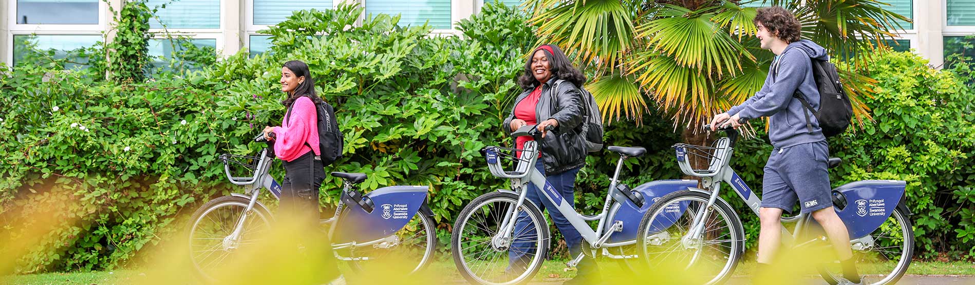 Students walking Swansea university Cycles through campus