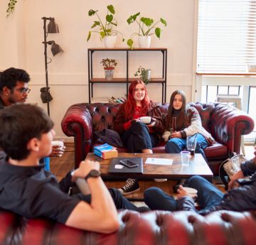 Student sitting down chatting 