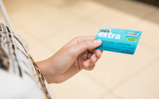 Hand holding an NUS card