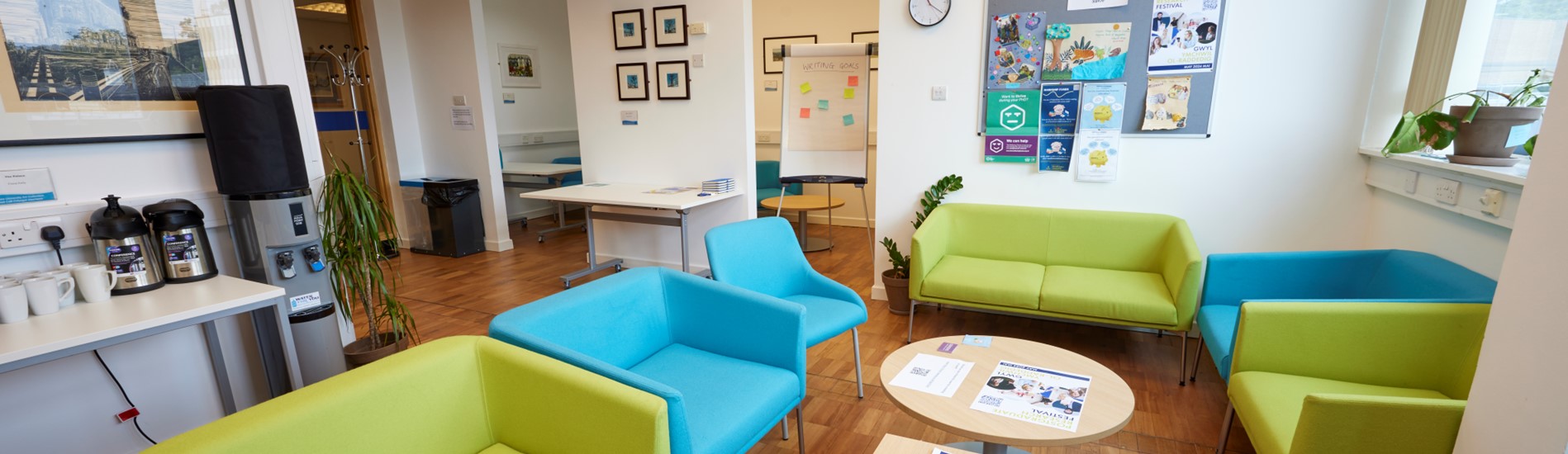 A room with green and blue couches