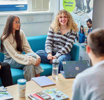 Students talking to a support staff member